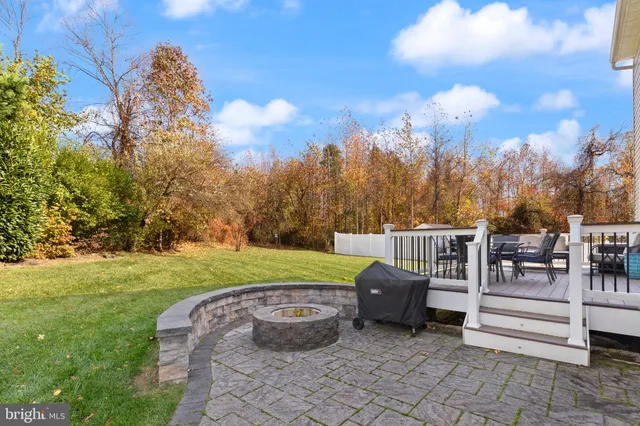 a view of a house with a big yard and large trees