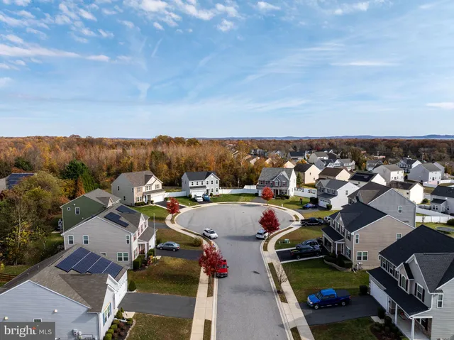 aerial view of a house with a yard and a garage