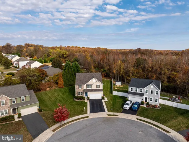 an aerial view of a house with a yard basket ball court and outdoor seating