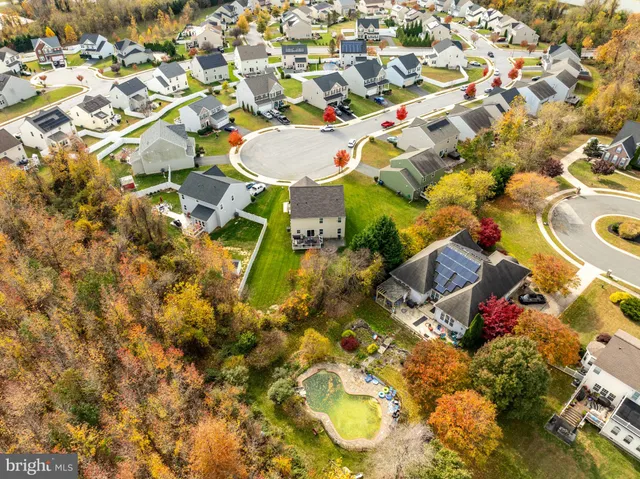 a aerial view of a house next to a yard