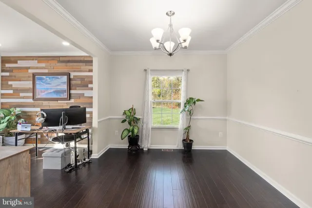 a view of a livingroom with furniture wooden floor and windows