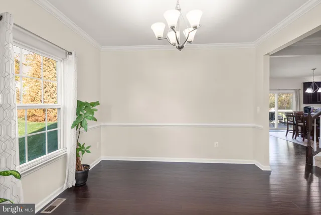 a view of livingroom with furniture wooden floor and chandelier