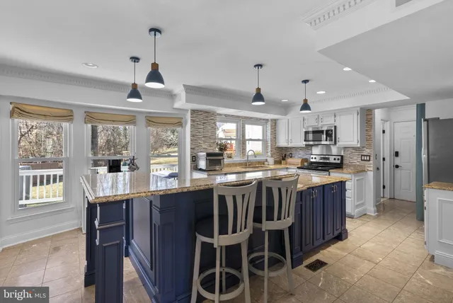 a kitchen with stainless steel appliances granite countertop a stove and a refrigerator