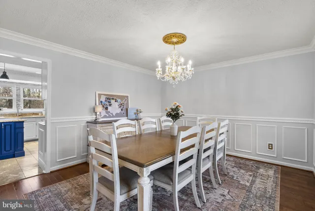 a view of a dining room with furniture and chandelier