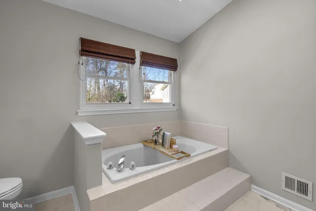 a white bath tub sitting next to a window