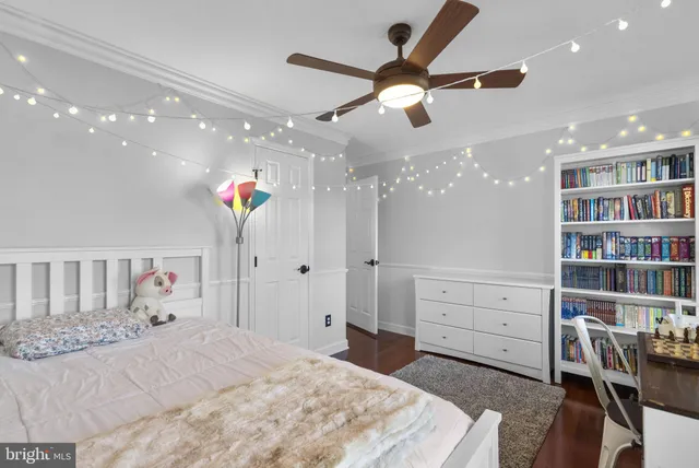 a bed room with a bed and a book shelf