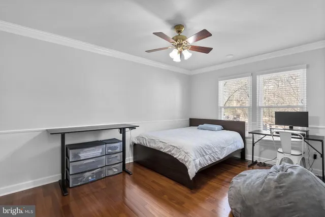 a bedroom with a bed a chandelier and a window