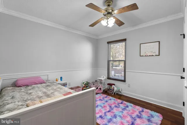 a bedroom with a bed dresser and a window