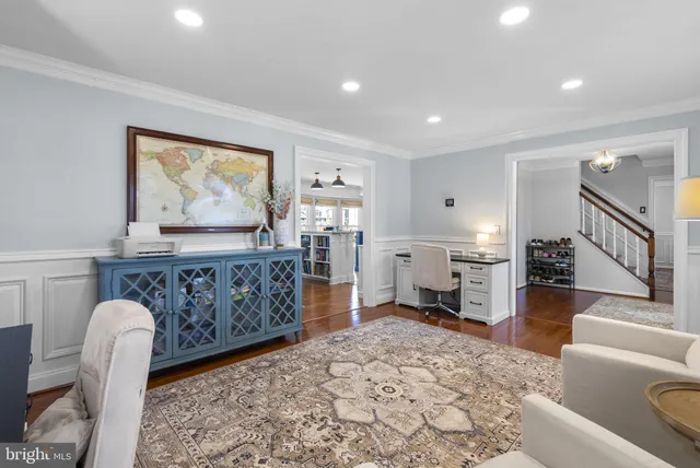 a living room with furniture and a dining table