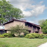 a front view of a house with a garden