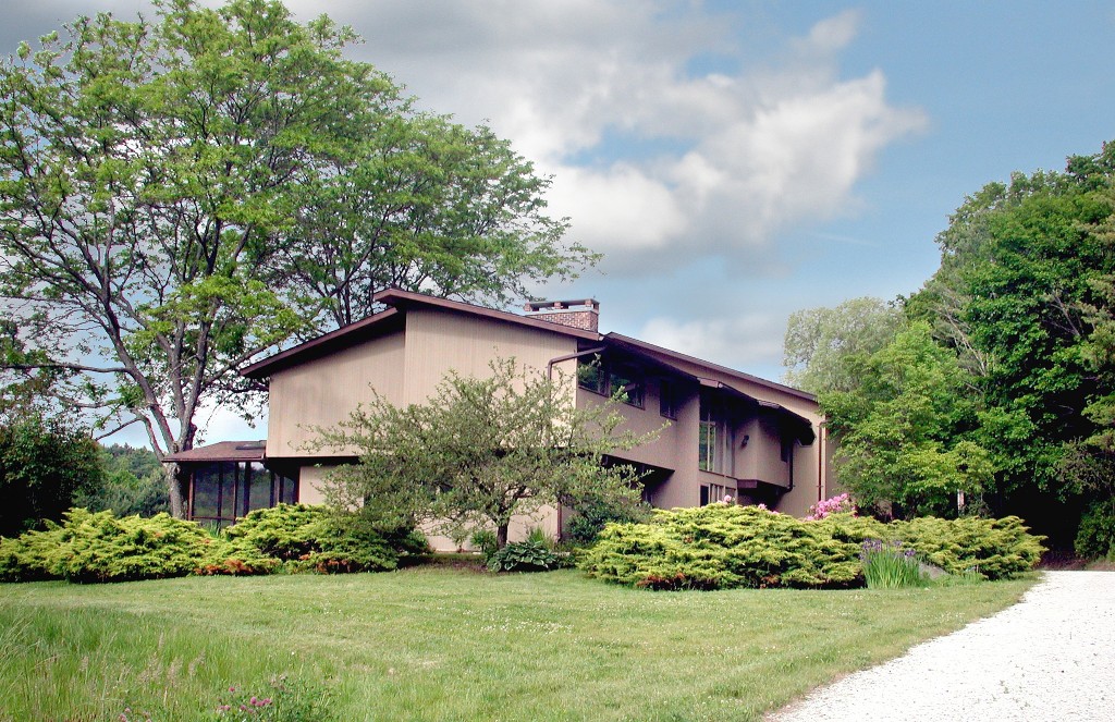a front view of a house with a garden