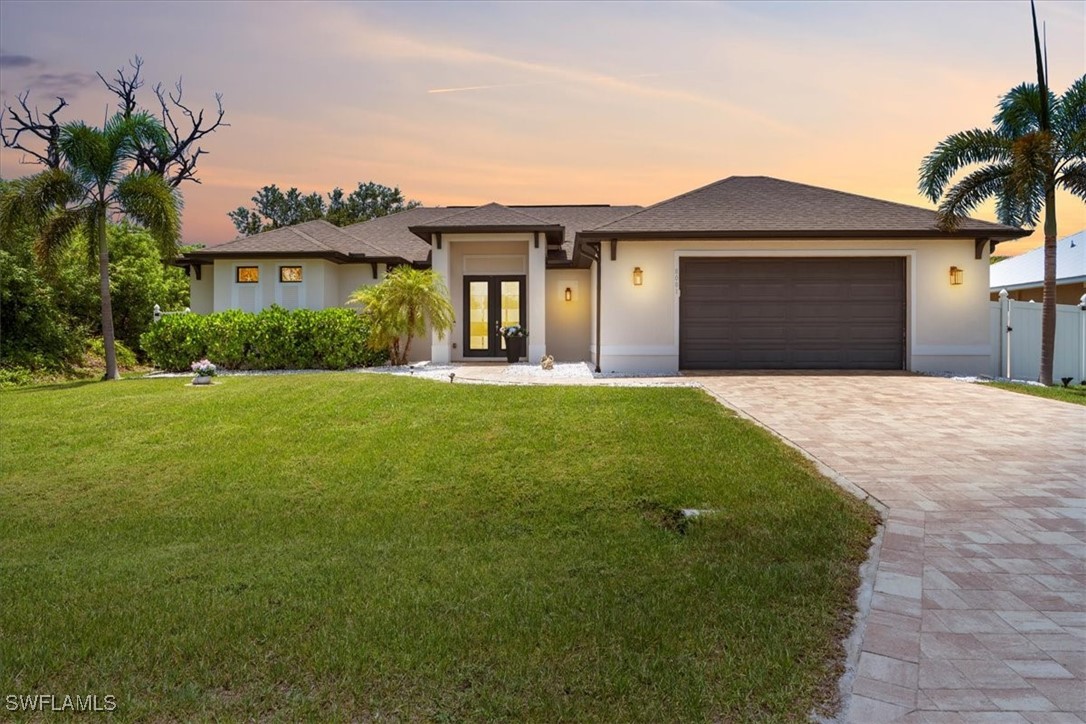 8081 Dimstead Street Port Charlotte, FL 33981 - Photo 1 of 42 a front view of a house with a yard and garage