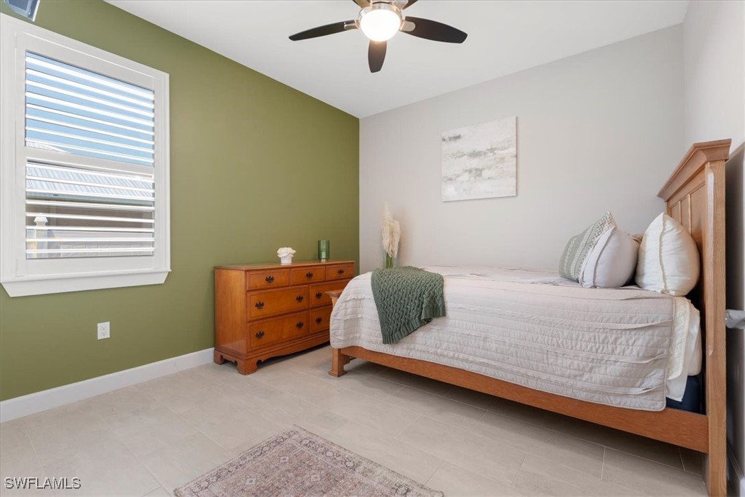 8081 Dimstead Street Port Charlotte, FL 33981 - Photo 17 of 42 a bedroom with a bed and a chandelier