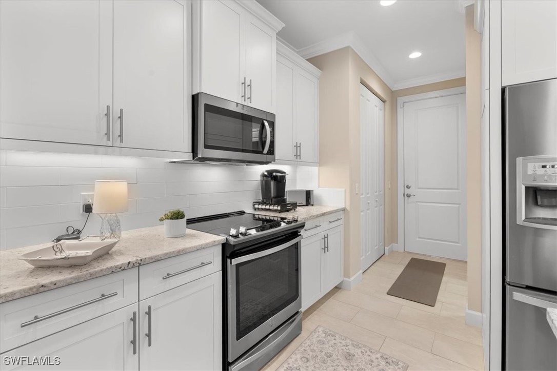 8081 Dimstead Street Port Charlotte, FL 33981 - Photo 10 of 42 a kitchen with a sink stove and refrigerator