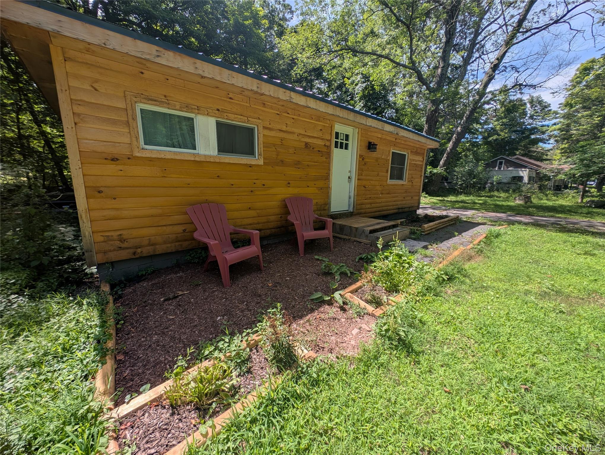 549 Hearts Content Road Cairo, NY 12473 - Photo 2 of 28 a view of a backyard with chairs and plants
