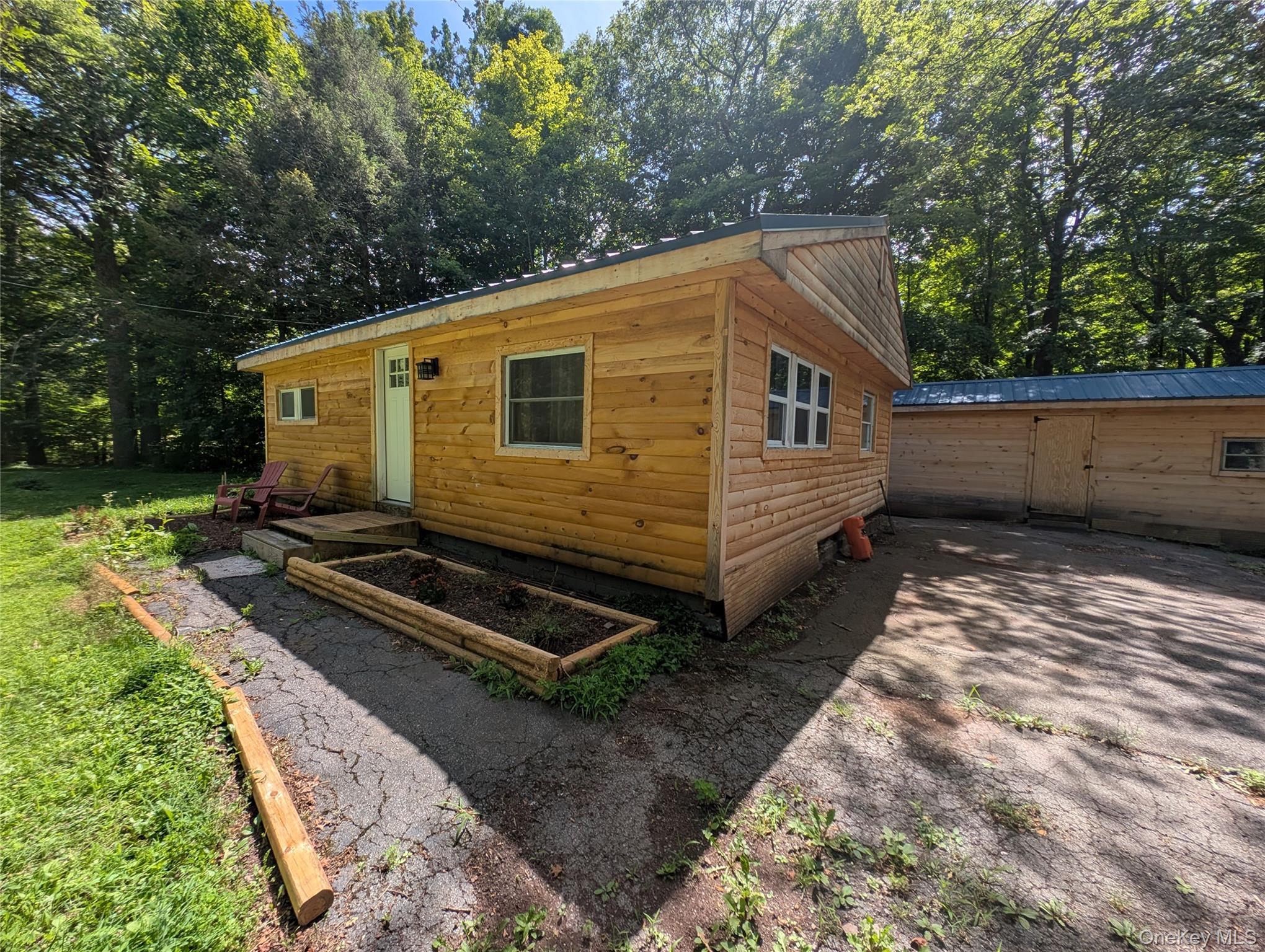549 Hearts Content Road Cairo, NY 12473 - Photo 21 of 28 a back view of a house with backyard and trees