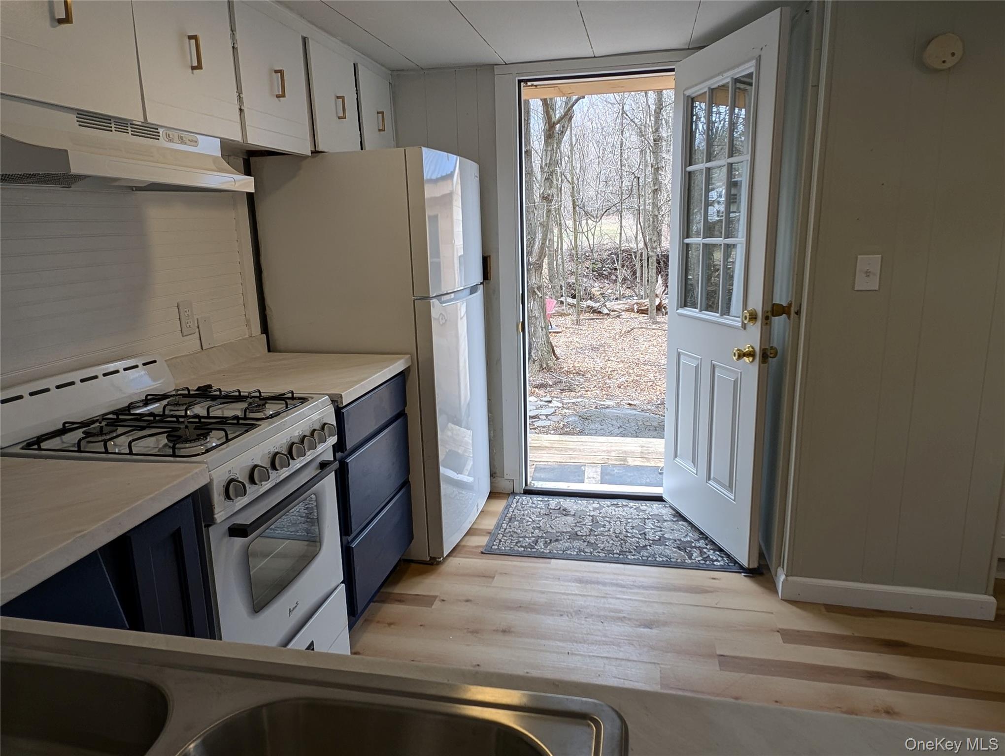 549 Hearts Content Road Cairo, NY 12473 - Photo 6 of 28 a kitchen with a stove and a refrigerator