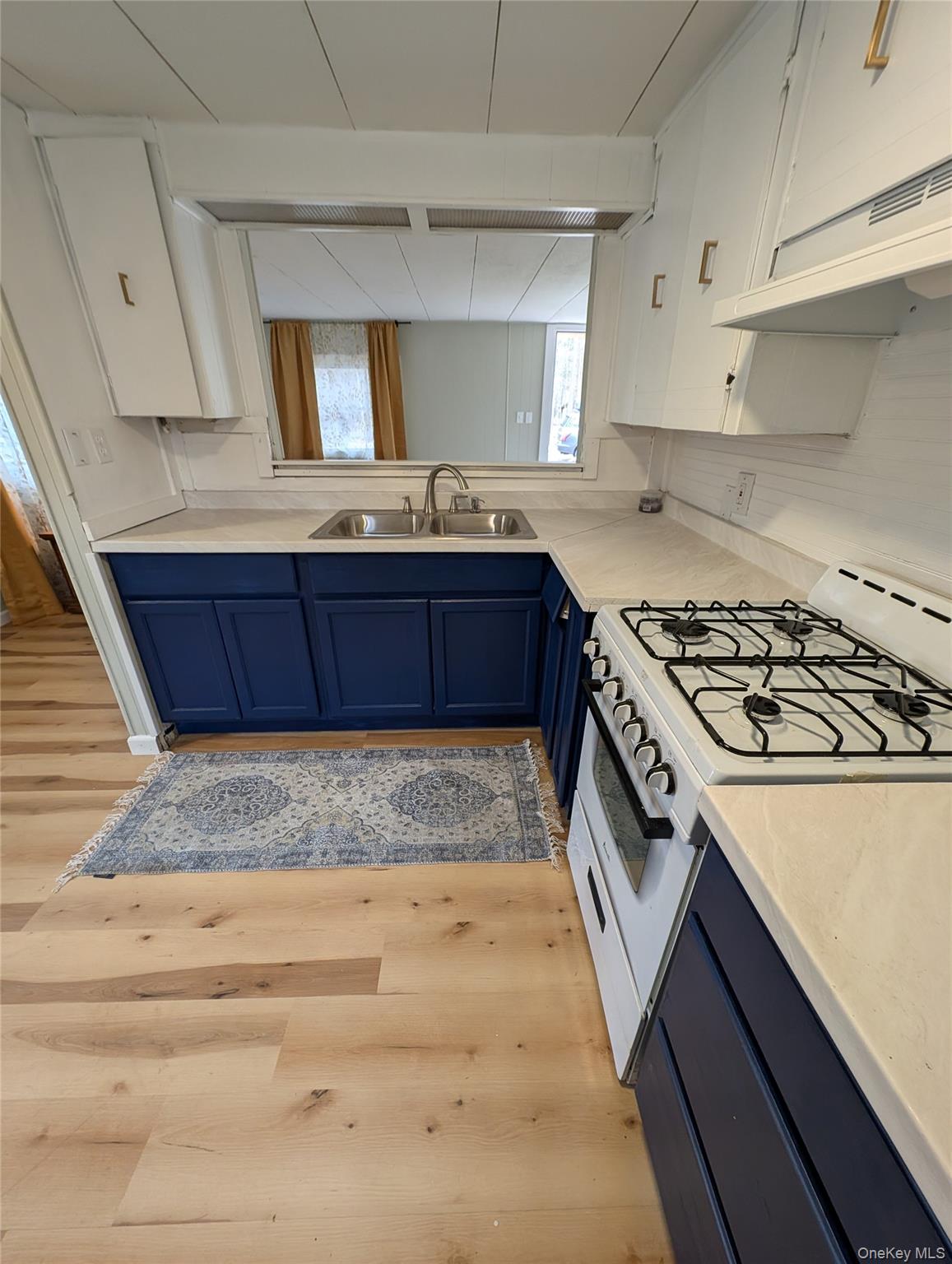 549 Hearts Content Road Cairo, NY 12473 - Photo 8 of 28 a kitchen with a stove a sink and a microwave