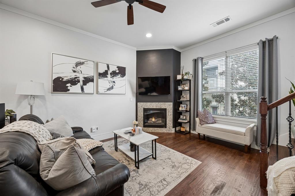 5875 Ross Avenue, Unit 9 Dallas, TX 75206 - Photo 10 of 29 Living room featuring ornamental molding, a ceiling fan, a glass covered fireplace, dark wood-type flooring, recessed lighting and ceiling fan.