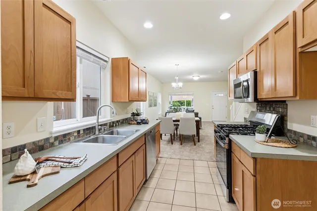 a kitchen with stainless steel appliances granite countertop sink stove and cabinets