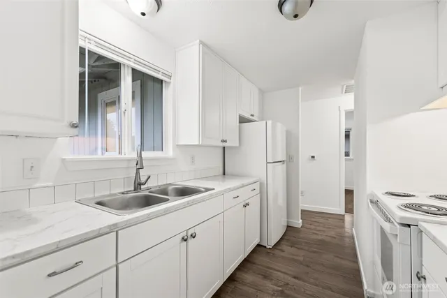 a kitchen with a sink and a refrigerator