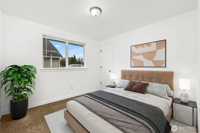 a bedroom with a bed and a potted plant