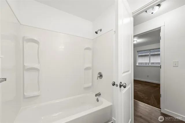 a bathroom with a bathtub and a shower