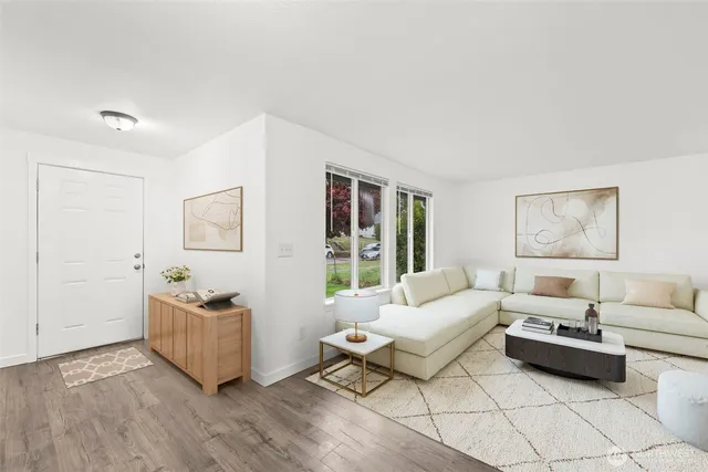 a living room with furniture and wooden floor