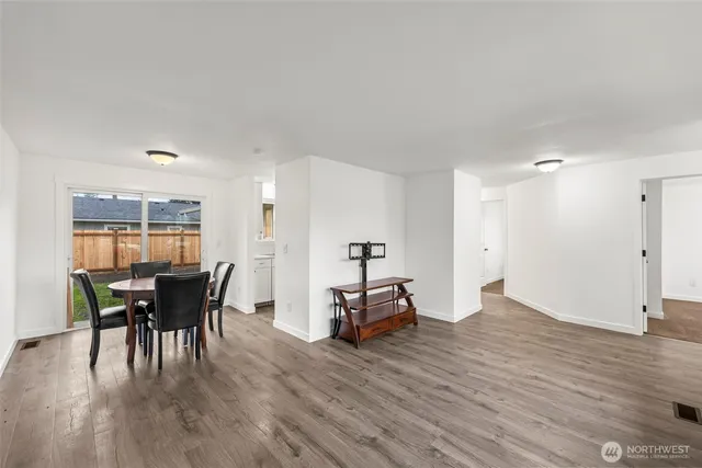 a dining room with furniture and wooden floor