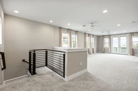a view of an empty room with a kitchen