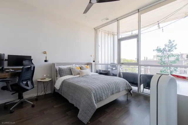 a bedroom with a bed a desk and chair