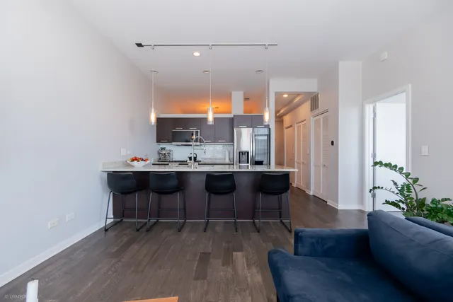 a view with a dining table chairs and a potted plant
