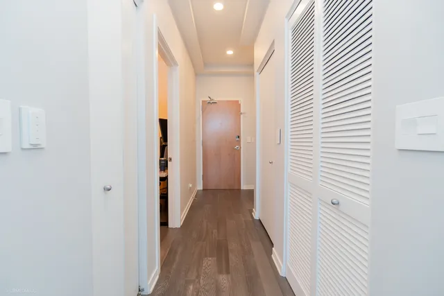 a view of a hallway with wooden floor