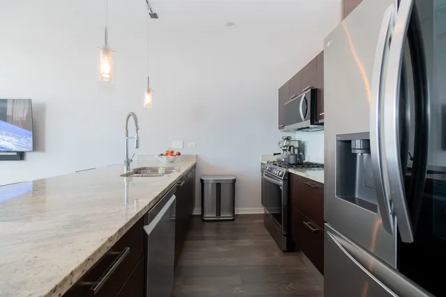 a kitchen with a sink stove and refrigerator