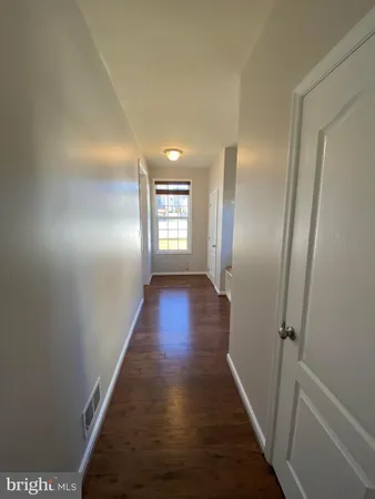 a white toilet sitting next to a window