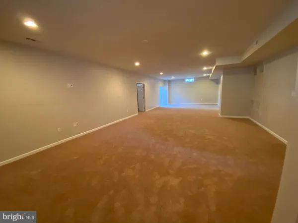 an empty room with a ceiling fan and a window