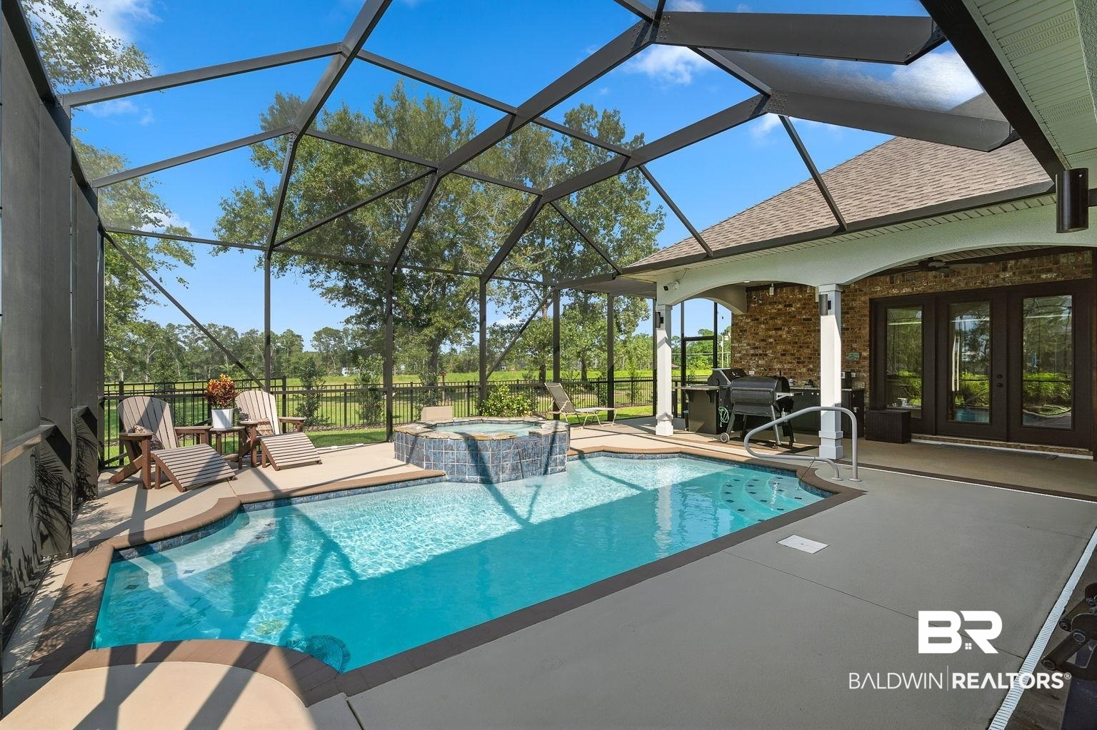 23357 Carnoustie Drive Foley, AL 36535 - Photo 26 of 99 View of swimming pool with a patio area, a lanai, a pool with connected hot tub, and french doors
