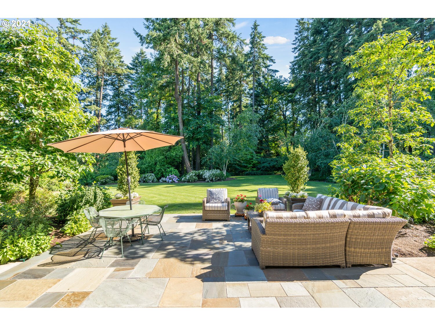 1925 South Military Road Portland, OR 97219 - Photo 15 of 32 a view of a patio with couches table and chairs under an umbrella