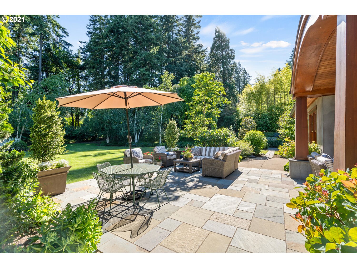 1925 South Military Road Portland, OR 97219 - Photo 4 of 32 a view of a patio with chairs and table under an umbrella