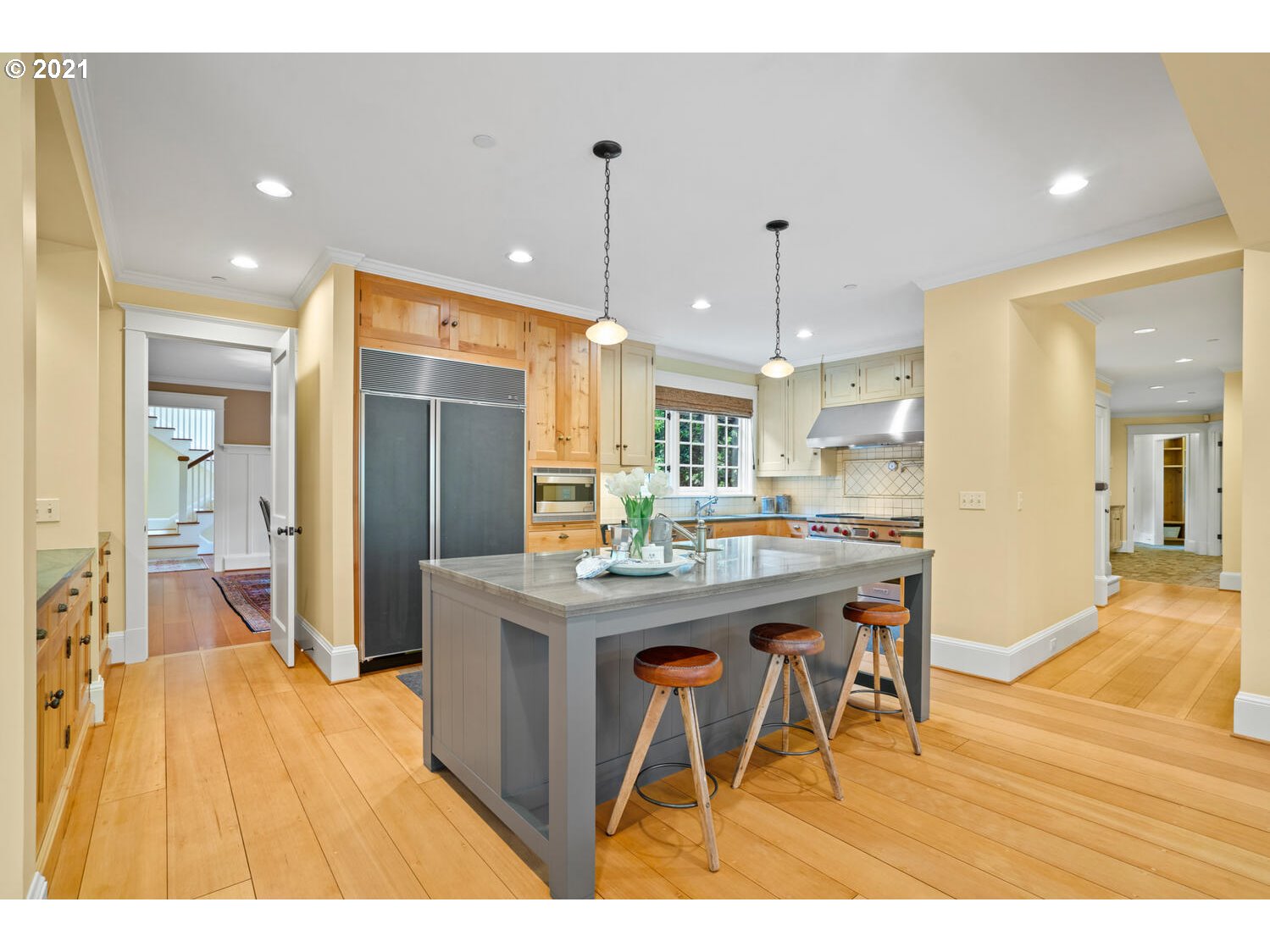 1925 South Military Road Portland, OR 97219 - Photo 10 of 32 a kitchen with stainless steel appliances kitchen island granite countertop a table chairs and a refrigerator