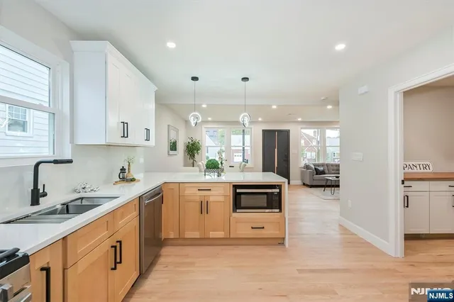 a kitchen with stainless steel appliances kitchen island granite countertop a sink and cabinets