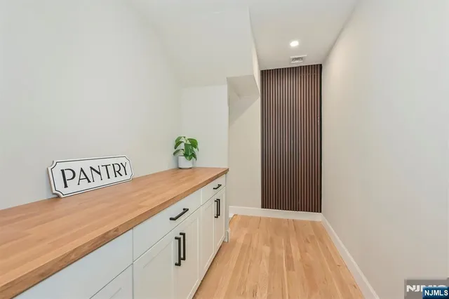 a view of hallway with wooden floor