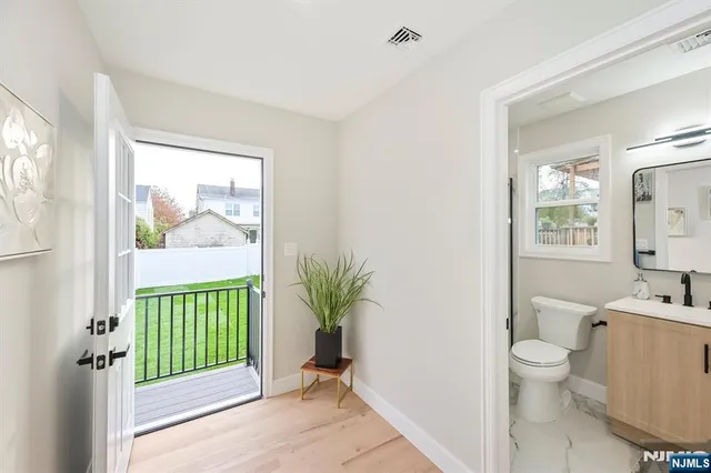 a bathroom with a toilet a sink and a window