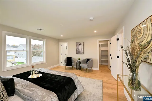 a large bedroom with a large bed and a large window