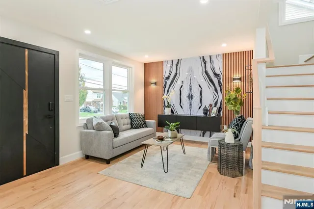 a living room with furniture and a floor to ceiling window
