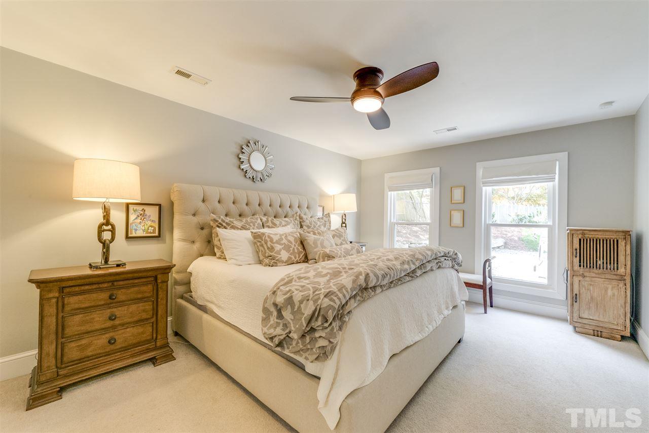 3105 Chancery Place Raleigh, NC 27607 - Photo 11 of 25 a spacious bedroom with a bed and closet with mirror