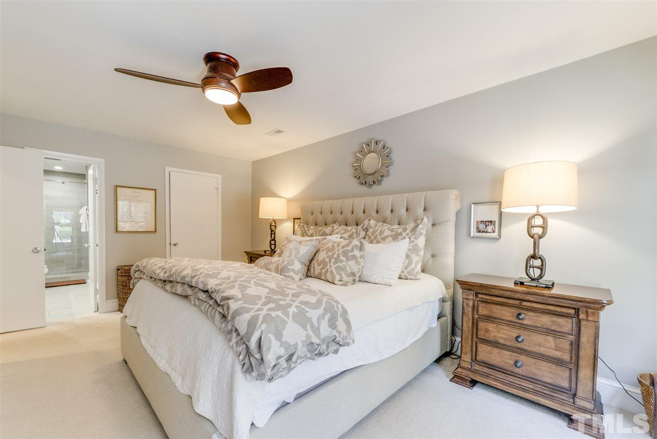 3105 Chancery Place Raleigh, NC 27607 - Photo 12 of 25 a bedroom with a bed and ceiling fan