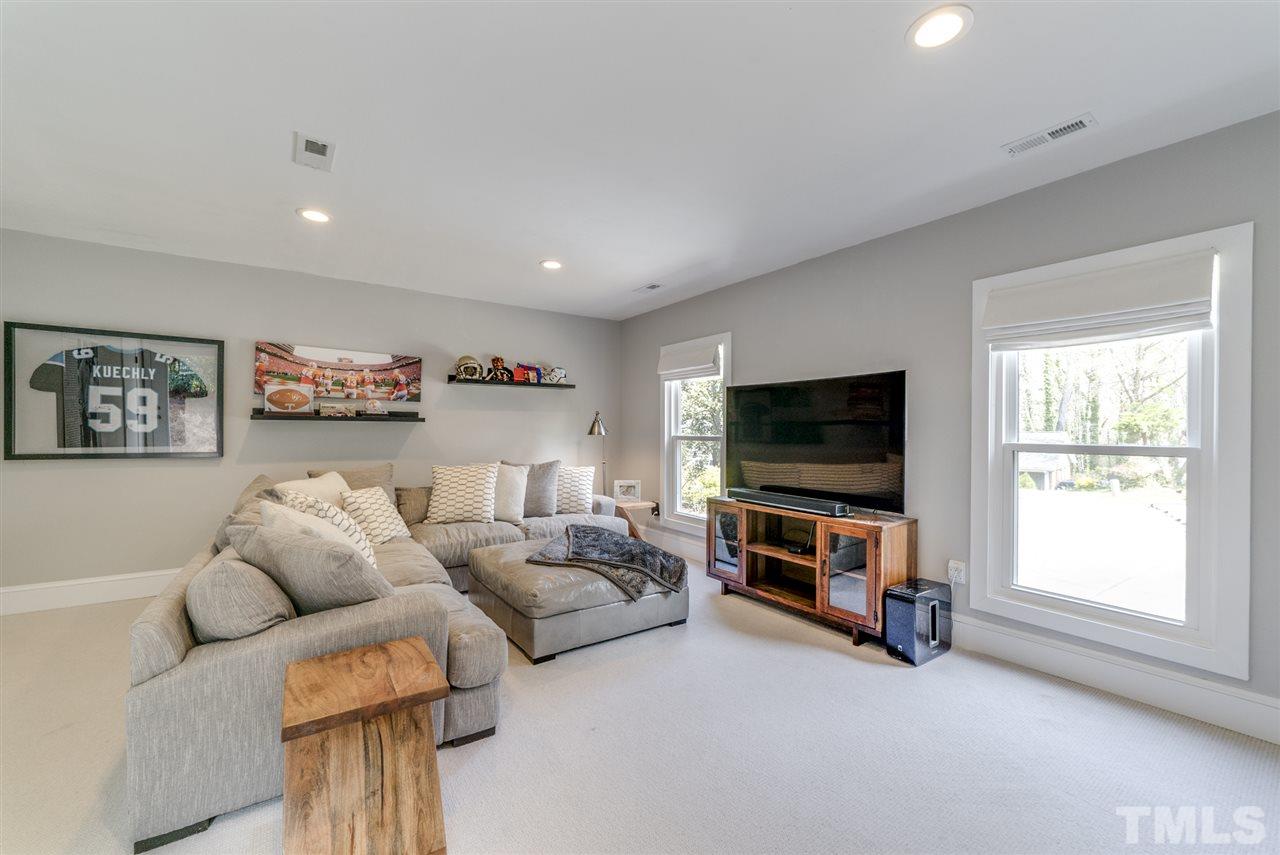 3105 Chancery Place Raleigh, NC 27607 - Photo 15 of 25 a living room with furniture and a flat screen tv