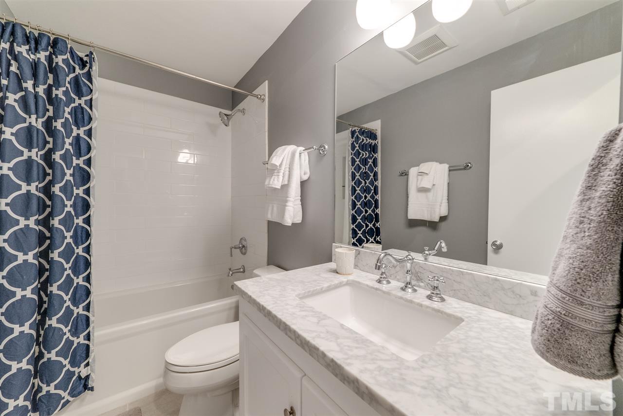 3105 Chancery Place Raleigh, NC 27607 - Photo 18 of 25 a bathroom with a granite countertop sink toilet mirror and shower