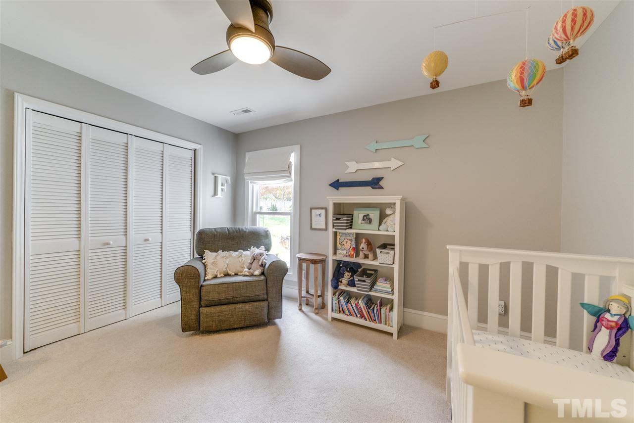 3105 Chancery Place Raleigh, NC 27607 - Photo 20 of 25 a living room with furniture and a book shelf